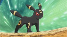 a black and yellow pokemon standing on top of a sandy beach next to the ocean