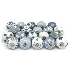 a pile of gray and white ceramic knobs