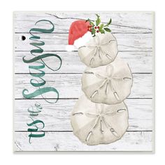 three sand dollars are stacked on top of each other with santa's hat on