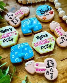 decorated cookies are arranged on a wooden table