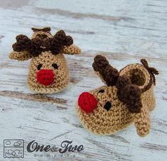 two crocheted reindeer slippers sitting on top of a wooden floor