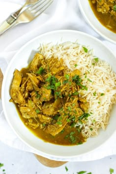 two white bowls filled with food and rice