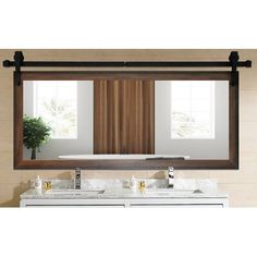 a bathroom vanity with two sinks and a large mirror