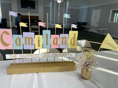 a table topped with wooden signs and flowers