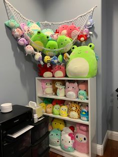 a shelf filled with lots of stuffed animals