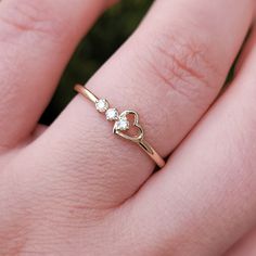 This 14k solid gold heart diamond ring is a delicate piece of jewelry for your everyday wearing. This will be a perfect gift for any occasion. This ring can be worn individually or with two or more stackable to create a unique look. Ring Features : - Custom Gold Color: Available Rose Gold, Yellow Gold, White Gold, in 14k - Shank Width:1.50mm - Diamond Shape: Round - Number of Stones: 3 stones of Mined Diamond (100% Real Diamonds ) - Diamond size: 1.7 mm - Total CTW: 0.06ctw - Diamond Color / Cla Dainty White Gold Heart Promise Ring, Dainty Heart Cut Stackable Promise Rings, Dainty White Gold Diamond Heart Ring, Dainty Heart-shaped Promise Birthstone Ring, Dainty Heart-shaped Rose Gold Diamond Ring, Dainty Heart Shaped Birthstone Promise Ring, Dainty Heart Birthstone Promise Ring, Dainty Rose Gold Heart-shaped Diamond Ring, Dainty Rose Gold Heart Diamond Ring