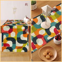 a table topped with plates and bowls filled with fruit next to a quilted table runner