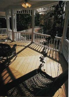 a porch with chairs and railings on it