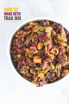 a bowl filled with nuts and raisins on top of a white countertop