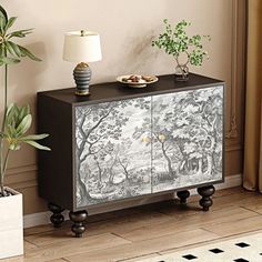 a black and white cabinet with trees on it