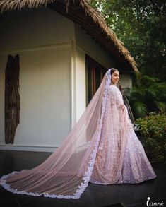 a woman in a pink wedding gown and veil