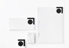 two notebooks with black circles on them next to each other and white paper in the middle