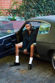 a man sitting in the door of a car