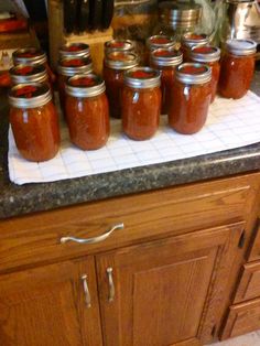 many jars are lined up on the counter