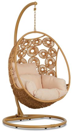 a swing chair that is hanging in the air with pillows on it and an attached cushion