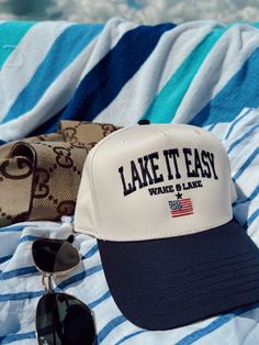 Lake it Easy! The perfect hat for hot summer days on the lake Navy Vintage hat with embroidery In collaboration with Aubrey Ships immediately unless on preorder! Vintage Trucker Hat, Neoprene Bag, Best Travel Accessories, Vintage Trucker Hats, School Collection, Hat Embroidery, Vintage Hat, Swimsuit Cover Ups, Sneaker Heels