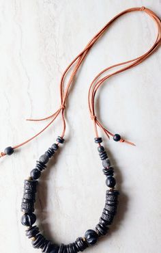 "Dark, organic, classic, everyday and everywhere. This necklace is 30\" in length. Soft beige-brown cord and array of black beads, disks, and spacers. This necklace is a staple wardrobe all year long. Would be beautiful on linen. Black African Recycled Glass beads in 12mm to 22mm in size.  Also a variety of wood beads, black disks, recycled glass beads, and fused glass. Full of interest and texture. Soft leather suede in natural beige-brown in this pull over head design. One-of-a-kind. The item/ Adjustable Beaded Necklaces For Everyday, Adjustable Everyday Beaded Necklaces, Adjustable Artisan Beaded Necklaces, Artisan Black Adjustable Beaded Necklaces, Artisan Black Adjustable Beaded Necklace, Artisan Black Beaded Necklaces With Adjustable Fit, Adjustable Black Artisan Beaded Necklace, Black Waxed Cord Jewelry For Everyday Use, Adjustable Brown Necklace With Black Beads