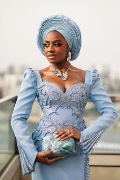 a woman in a blue dress and head scarf