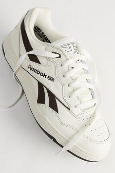 Vintage-inspired chunky basketball sneakers by Reebok. Coated leather upper with a lace closure. Cushioned feel with an EVA midsole and finished with textured tread at the rubber outsole. Features Retro look basketball shoes from Reebok Lace closure front Textured rubber outsole Content + Care Leather, rubber Spot clean Imported | Reebok BB4000 II Basketball Sneaker in Brown, Men's at Urban Outfitters Reebok Bb 4000 Ii Outfit, Reebok Shoes For Men, Mens Reebok Shoes, Classic Leather Reebok, Reebok Classic Leather Black, Reebok Classic Leather Sneakers, Men’s Reebok Sneakers, Leather Sneakers Men, Sneakers Outfit Men