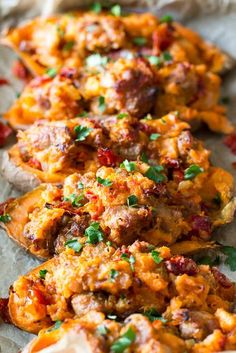 baked sweet potatoes with meat and herbs on parchment paper