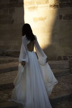 the back of a woman's dress as she walks up some steps