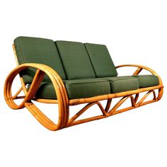 a wooden chair with green cushions sitting on top of it's backrests