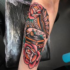 a person with a tattoo on their arm has a rose and an old fashioned grinder