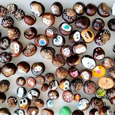 there are many different types of donuts on the table with faces painted on them