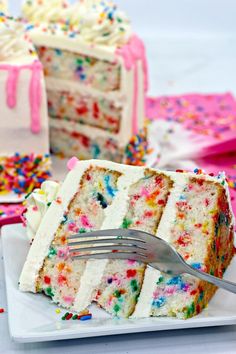 a slice of cake with sprinkles on it and a fork next to it