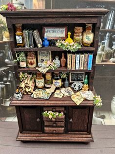 an old fashioned book shelf with books and other items on it's display case