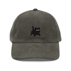 a gray hat with a black cat embroidered on it