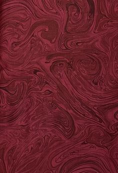 a red background with swirls and waves on it's surface, as well as the