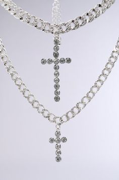 Double the drip. The AKIRA Label Iced Out Necklace Set contains a set of two rhinestone-embellished cuban chain links of varying lengths and width. The shorter chain features a wider design, with a large dangling cross pendant made of circular gemstones, while the longer chain has a thin silhouette and features a smaller, coordinating cross pendant. Stack together or wear separately for a look icier than Elsa herself. - 100% Man-Made Materials (all measurements approximate from size O/S)- 16”, 23” Circumference- 2.5”, 1.25” Pendant Length- Imported Product ID: 347756 Chain Links, Cuban Chain, Long Chain, Cross Pendant, Chain Link, Necklace Set, Necklaces, Gemstones, Chain