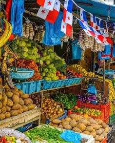 an outdoor market with many different fruits and vegetables