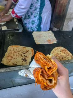 a person holding up some food in their hand