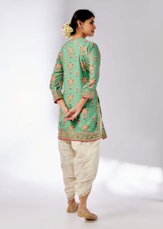 This enchanting ensemble features a floral jaal design, harmoniously combining gota and dori buttis with intricate border embroidery. The short kurta, paired with a dhoti adorned in sequins and gold thread, exudes feminine grace and elegance. Perfect for special occasions, this set effortlessly blends traditional craftsmanship with modern sophistication. Traditional Cotton Silk Tunic Kurta, Anarkali Style Cotton Sherwani With Floral Embroidery, Festive Cotton Silk Tunic Kurta, Festive Salwar Kameez With Resham Embroidery, Traditional Sets With Resham Embroidery Tunic, Festive Tunic Salwar Kameez For Navratri, Festive Navratri Salwar Kameez Tunic, Festive Tunic Salwar Kameez With Resham Embroidery, Navratri Sherwani With Gota Work And Straight Kurta