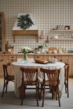 a table with four chairs around it in a kitchen