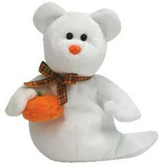 a white teddy bear holding a small orange pumpkin