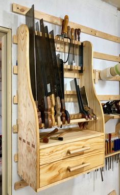 a work bench made out of wood with lots of tools hanging from it's sides