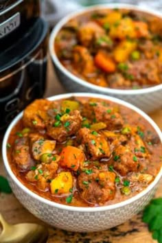 two bowls filled with stew next to an instant pot