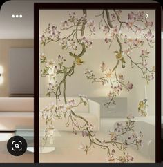 a living room filled with white furniture and flowers on the glass wall covering it's walls