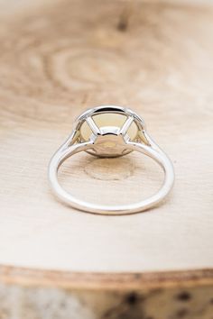 a close up of a ring on top of a wooden table