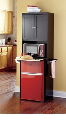 a red refrigerator freezer sitting inside of a kitchen