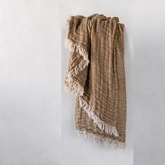 a brown and white towel hanging on the wall