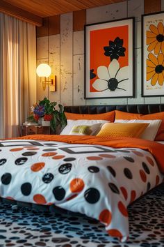 a bed with orange and black polka dots on it