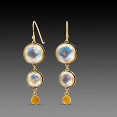 A pair of luminous moonstones are accented with a tiny 22k gold disk in each of these lovely earrings. Set in bezels of 22k gold, and backed with sterling silver. 18k gold earwires. Earrings hang approximately 1 1/2 inches. Matte finish. Gold Hand-forged Moonstone Earrings, Gold Hand Forged Moonstone Earrings, Gold Moonstone Hand Forged Earrings, Hand Forged Gold Moonstone Earrings, Moonstone Round Yellow Gold Earrings, Round Moonstone Yellow Gold Earrings, Moonstone Yellow Gold Round Earrings, Yellow Gold Round Moonstone Earrings, Round Gold Moonstone Earrings