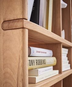 books are stacked on top of each other in a book shelf with the word tony robinis