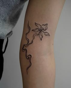 a woman's arm with a tattoo design on the left side of her body