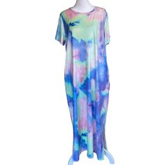 This Nagoo Brand New With Tags T-Shirt Dress Is Offered In A Size L. It Features A Fun And Colorful Tie-Dye Pattern In Shades Of Blue, Green, Purple And Pink. The Short-Sleeved, Round-Neck Dress Is Perfect For Summer And Spring Occasions, Whether You're Traveling Or Enjoying A Casual Day Out. The Pullover Closure And Jersey Fabric Make It Easy To Wear And Comfortable, While The Pockets Add A Practical Touch. The Dress Has Slits On The Sides At The Bottom For Easy And Comfortable Movement. It Is Machine Washable And Made Of A Blend Of Polyester And Spandex, Ensuring Durability, Comfort And Easy Care. Please See Photos For Condition. Blue Maxi Dress For Summer Loungewear, Summer Short Sleeve Maxi Loungewear Dress, Spring Multicolor Relaxed Fit Maxi Dress, Summer Short Sleeve Maxi Dress For Loungewear, Multicolor Relaxed Fit Maxi Dress For Spring, Summer Maxi Dress For Loungewear With Short Sleeves, Trendy Tie Dye Summer Dresses, Casual Blue Maxi Dress With Relaxed Fit, Casual Blue Relaxed Fit Maxi Dress