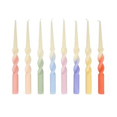 six candles are lined up in different colors